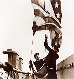 Sailors raise a flag aboard the USS Princeton